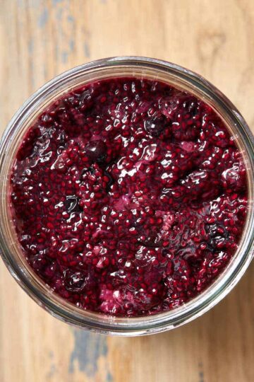Overhead view of triple berry chia seed jam in a glass jar.