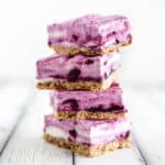 Side view of 4 blueberry frozen yogurt bars stacked on top of each other.