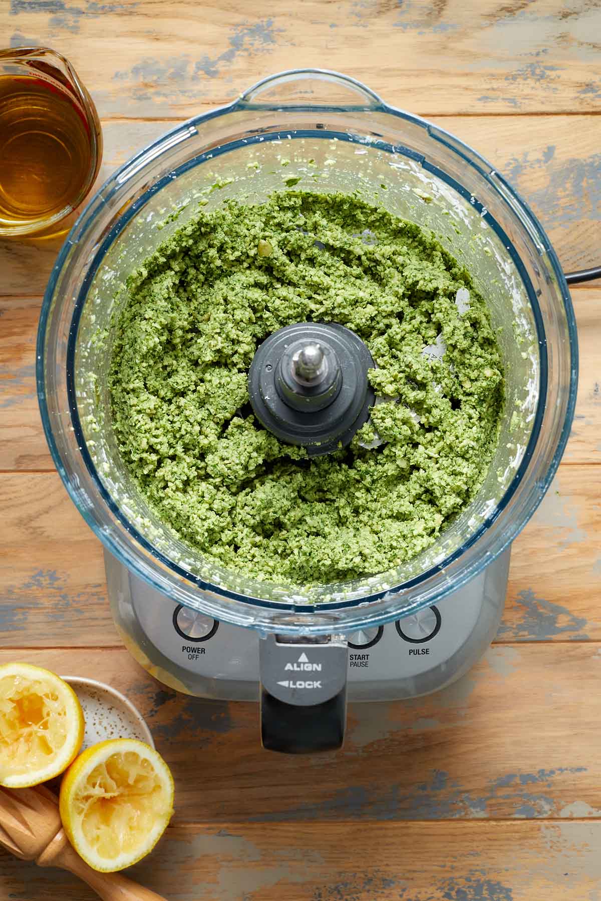 Pesto ingredients partially blended in a food processor.