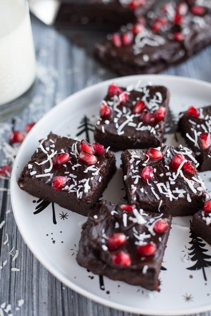 Up-close view of Peppermint Mocha Fudge Avocado Brownies on a white Christmas plate.