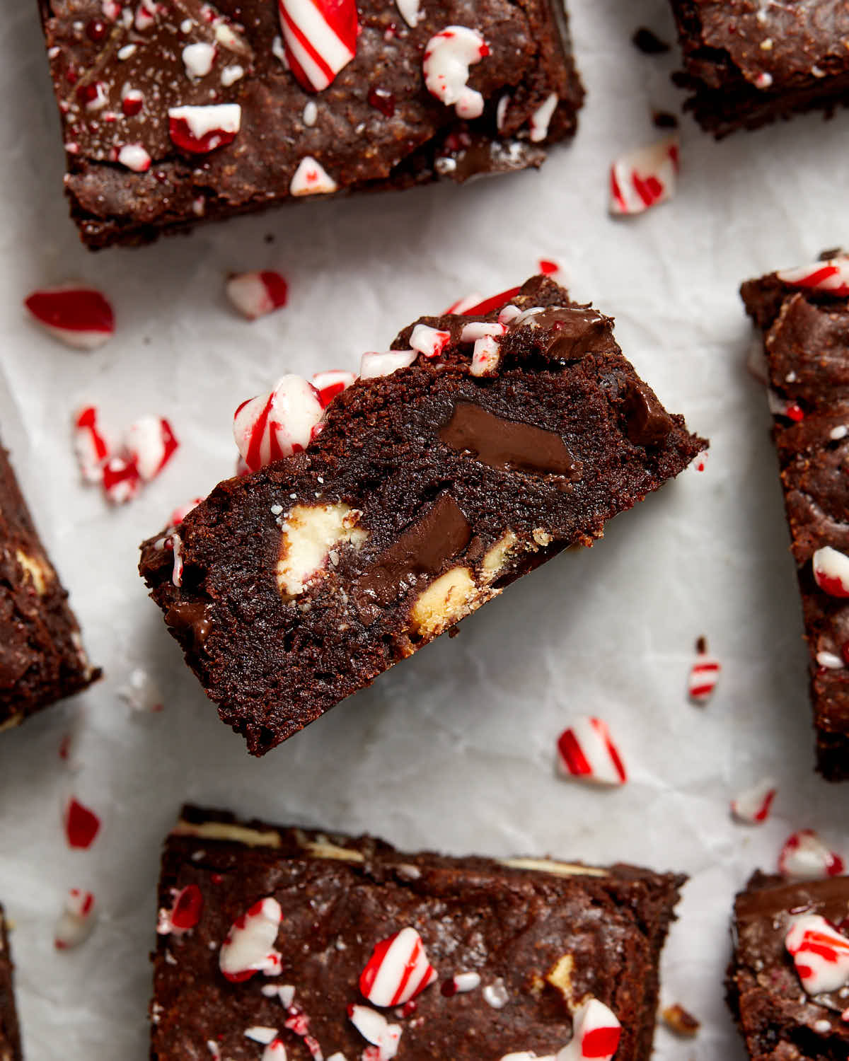 Brownie turned on its side to show the chunks of peppermint bark inside.