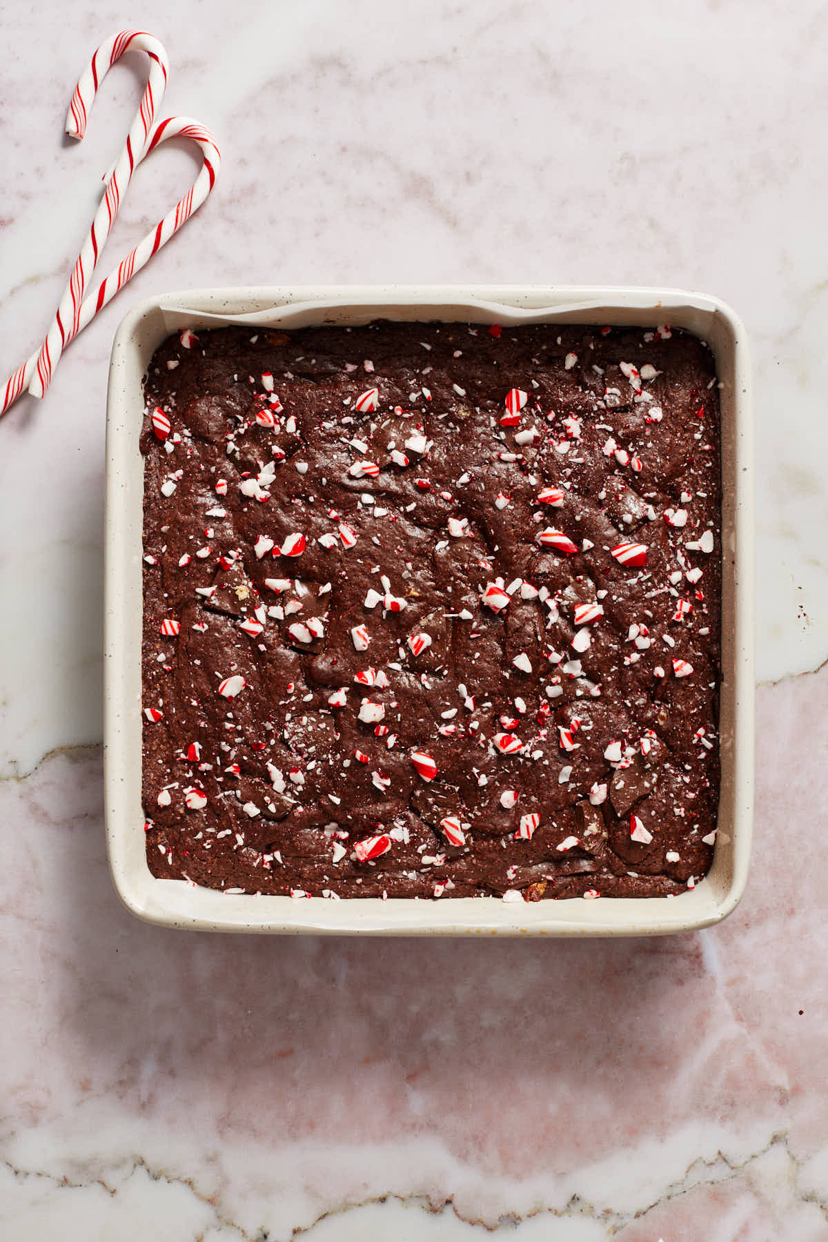 Fully baked brownies in the pan and topped with crushed candy canes.