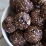 Close up of chocolate cherry energy bites piled in a bowl.