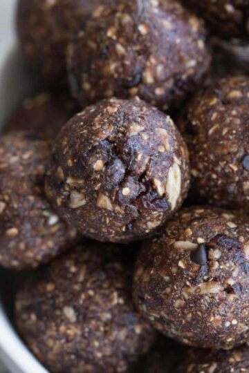 Close up of chocolate cherry energy bites piled in a bowl.