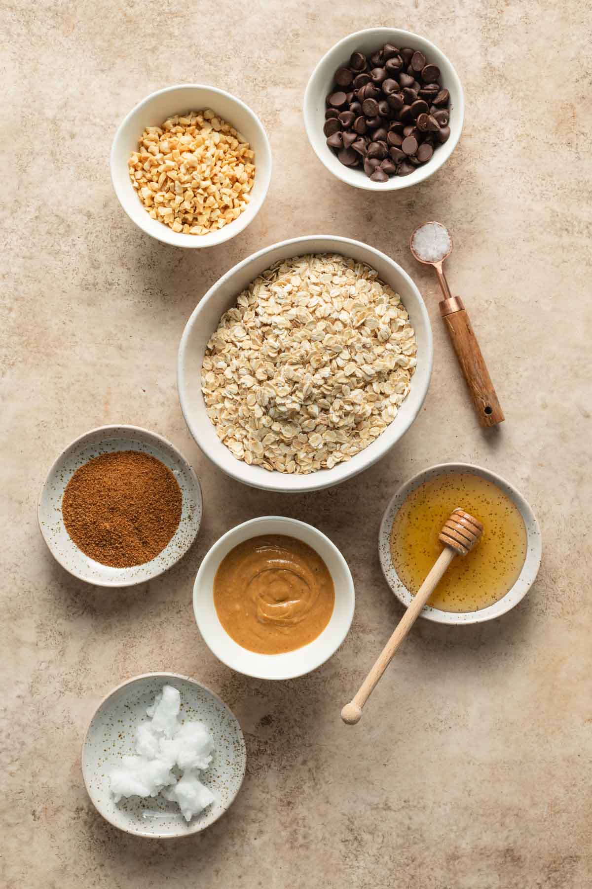 Ingredients to make peanut butter granola arranged individually.
