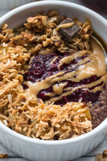 Overhead of chocolate peanut butter chia pudding in a small white bowl with a spoon.