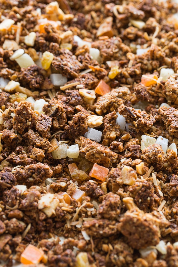 Up-close view of Coconut Cashew Crunch Grain-Free Granola spread out on a baking sheet.