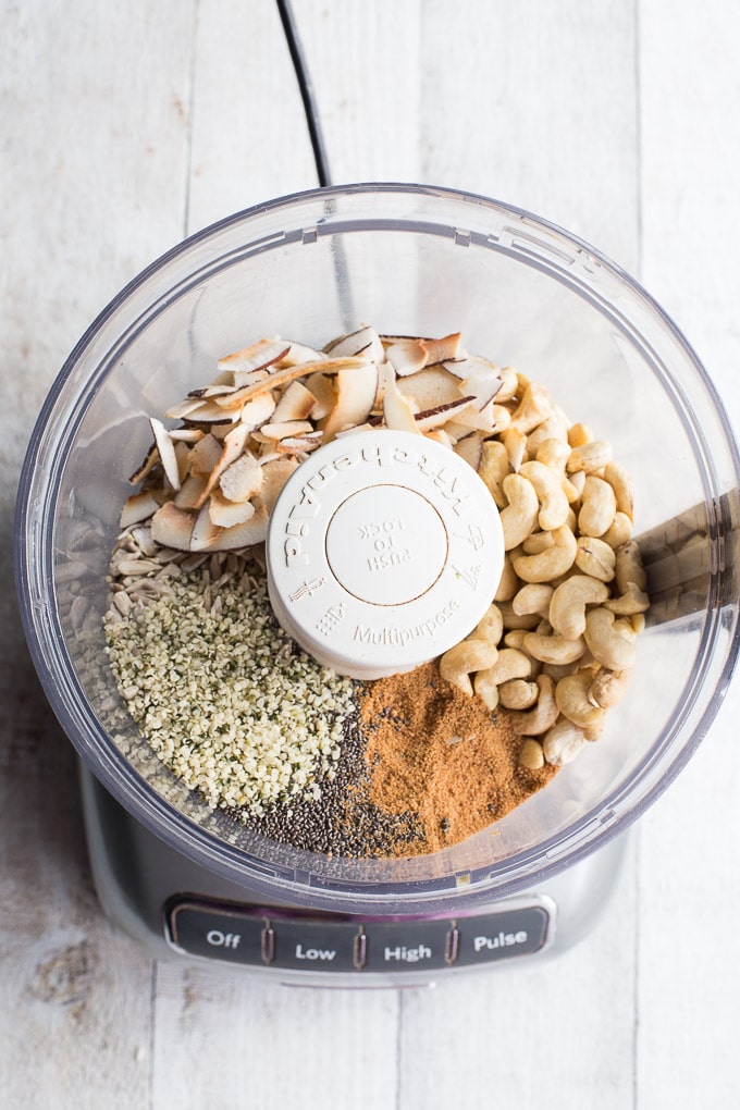 Overhead view of ingredients for Coconut Cashew Crunch Grain-Free Granola in a food processor.