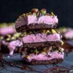 Side view of a stack of strawberry goat cheese bars.
