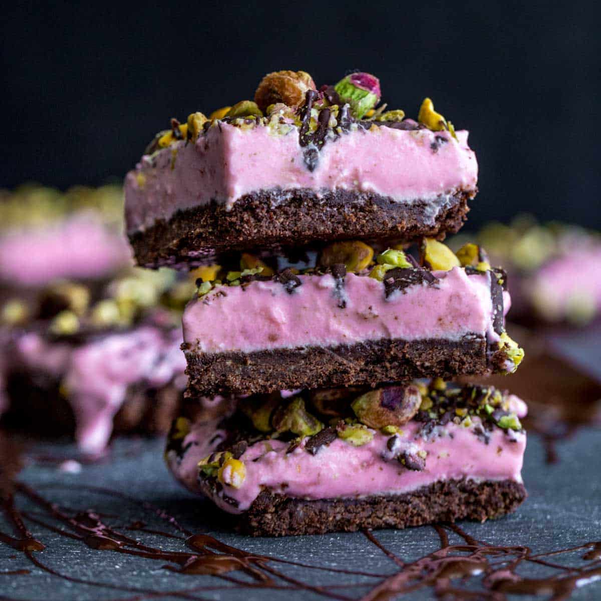 Side view of a stack of strawberry goat cheese bars.