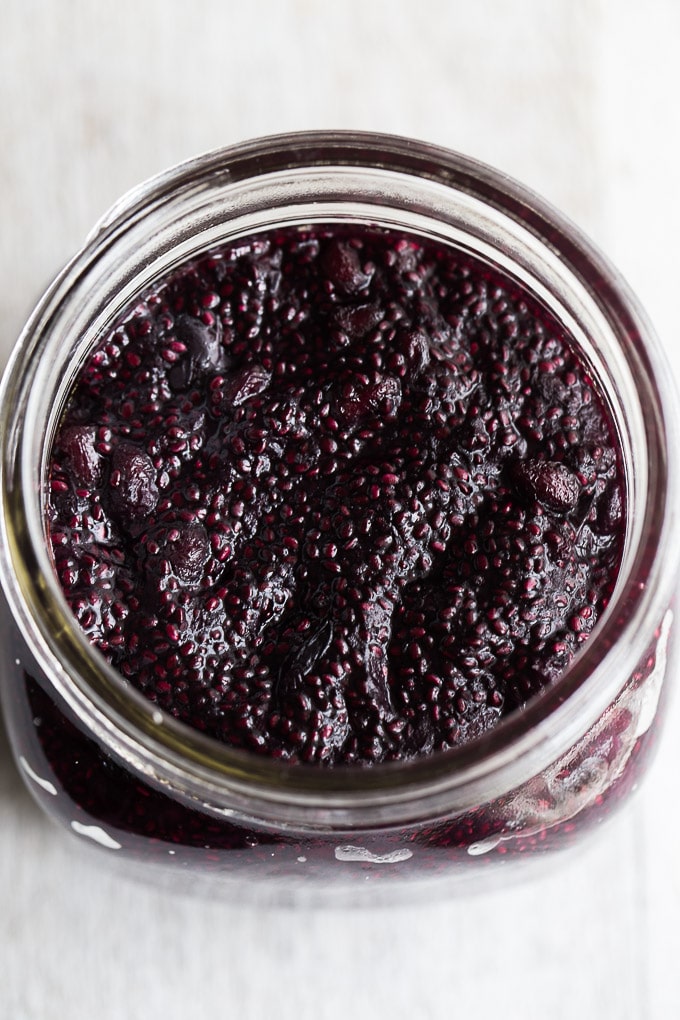 Up-close overhead view of Blueberry Pomegranate Chia Jam in a glass jar.
