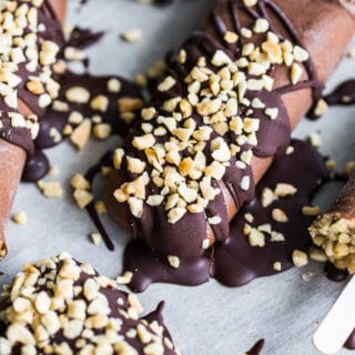 Up close view of Chocolate Peanut Butter Mocha Nice Cream Pops on parchment paper.