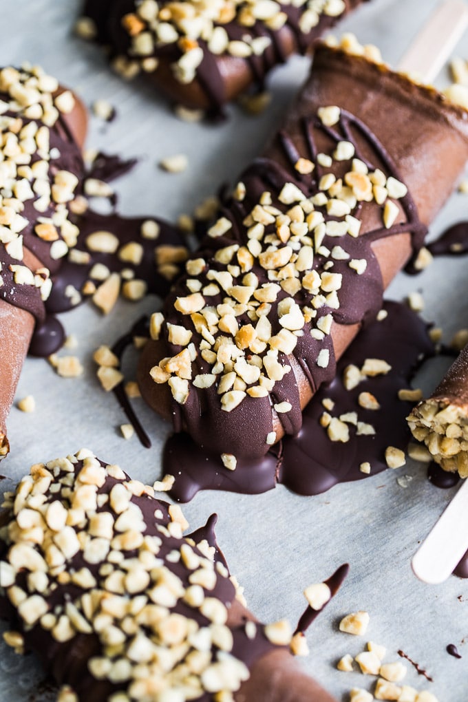 Up-close view of Chocolate Peanut Butter Mocha Nice Cream Pops on parchment paper.