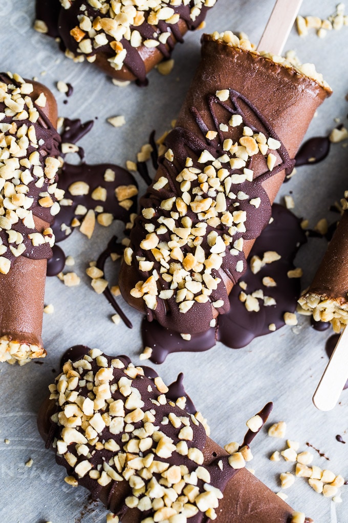 Overhead view of Chocolate Peanut Butter Mocha Nice Cream Pops on parchment paper.