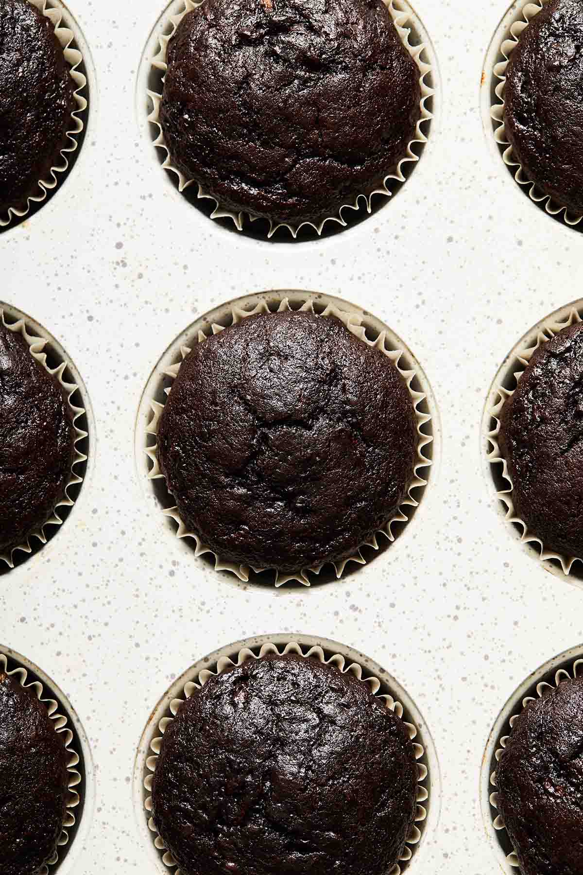 Cupcakes baked up in a muffin pan.