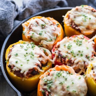 Up close view of Vegetarian Stuffed Peppers in a black cast iron pan.