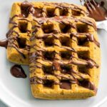 Close up of pumpkin spice waffles on a plate.