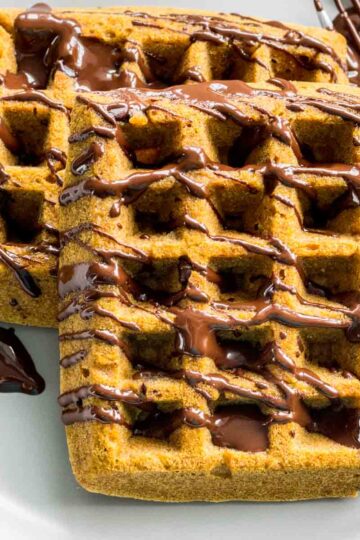 Close up of pumpkin spice waffles on a plate.