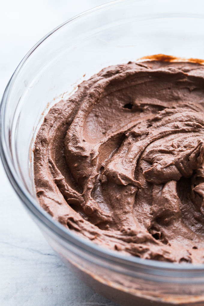 Up-close view of the dairy-free chocolate cream cheese mixture in a glass bowl.