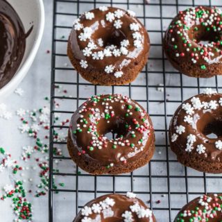 Overhead view of Mini Gingerbread Protein Donuts with Chocolate Glaze on a wire rack.