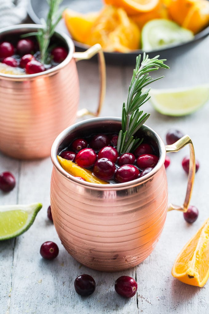 Orange Cranberry Kombucha Moscow Mules in copper mugs.