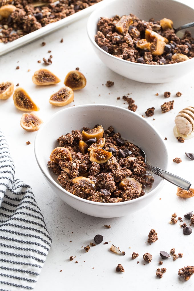 Chocolate Fig Grain-Free Granola in white bowls on a white surface.
