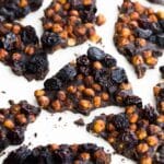 Overhead close up of chocolate chickpea bark broken into pieces.