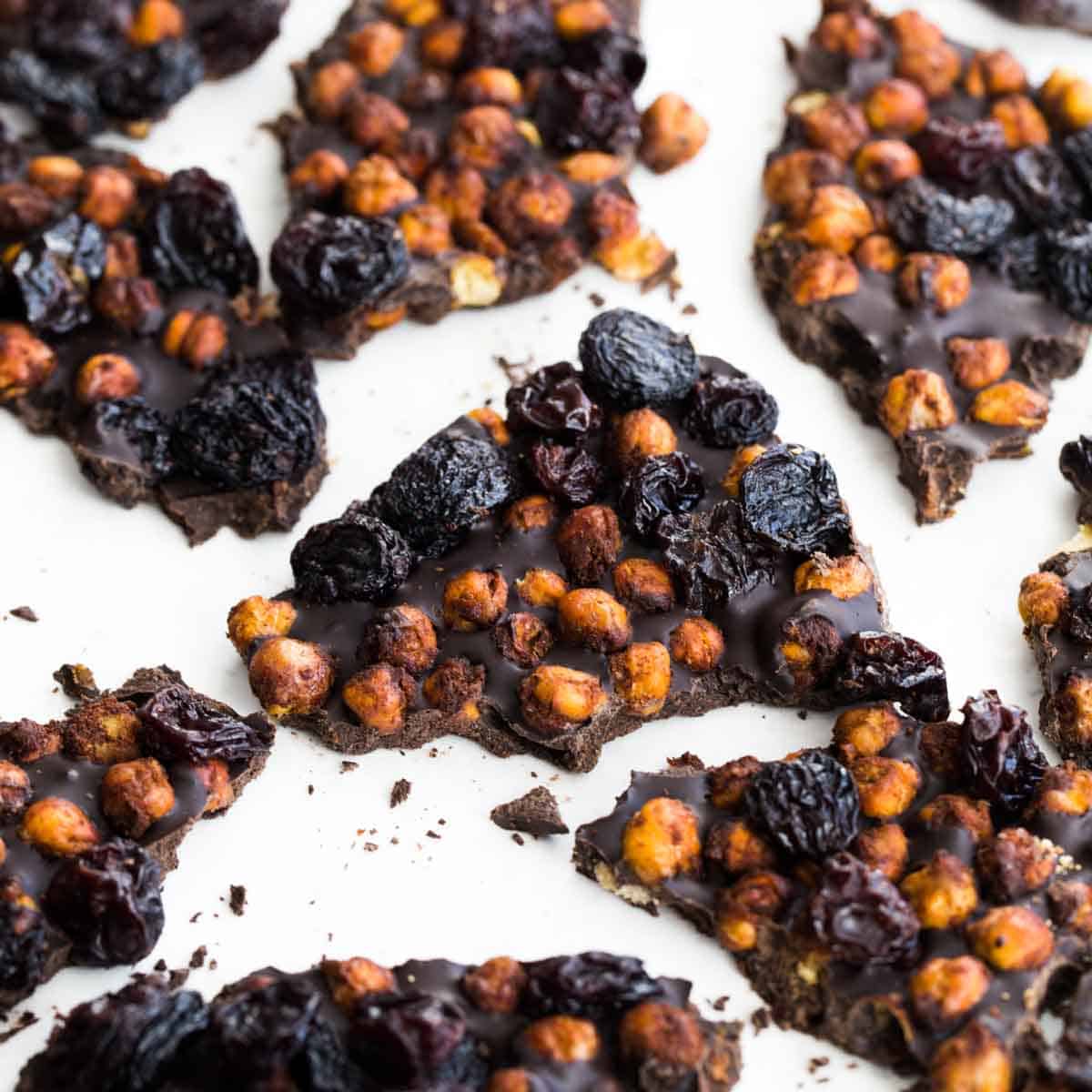 Overhead close up of chocolate chickpea bark broken into pieces.
