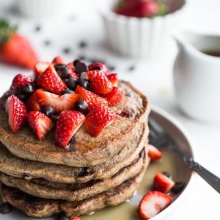 Stack of Strawberry Chocolate Chip Buckwheat Pancakes on a grey plate.