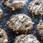 Angled view of morning glory breakfast cookies on a black wire rack.