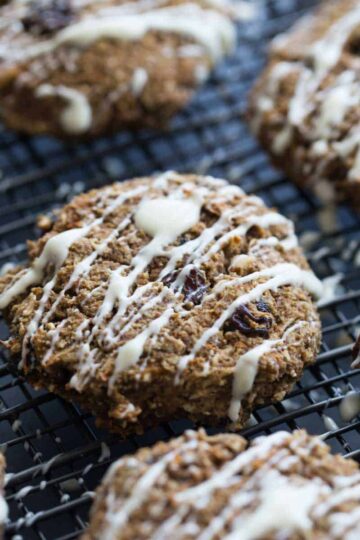 Angled view of morning glory breakfast cookies on a black wire rack.