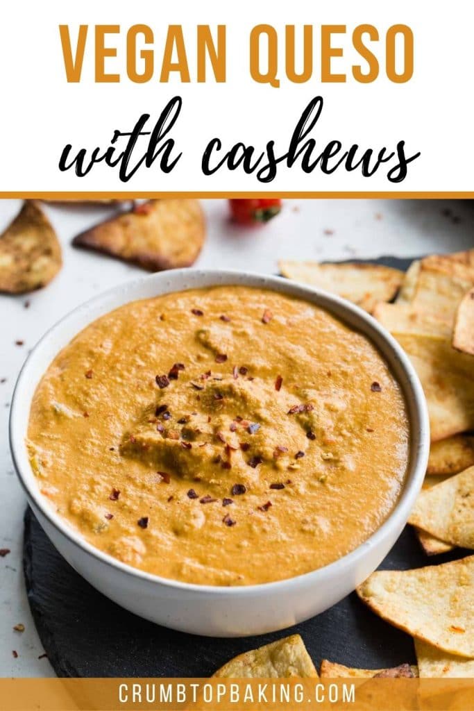 Pinterest image of cashew queso in a white bowl with chips on the side.