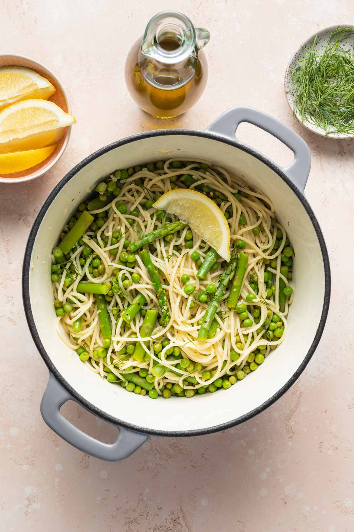 Lemon garlic pasta with peas and asparagus in a pot.