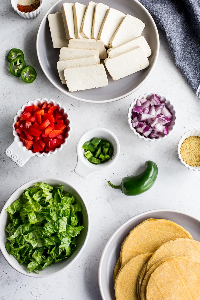 Overhead view of ingredients to make spicy tofu scramble breakfast tacos.