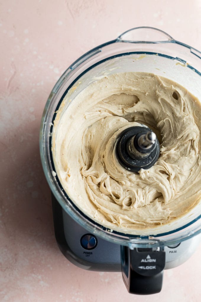 Overhead view of the creamy banana mixture in the food processor.