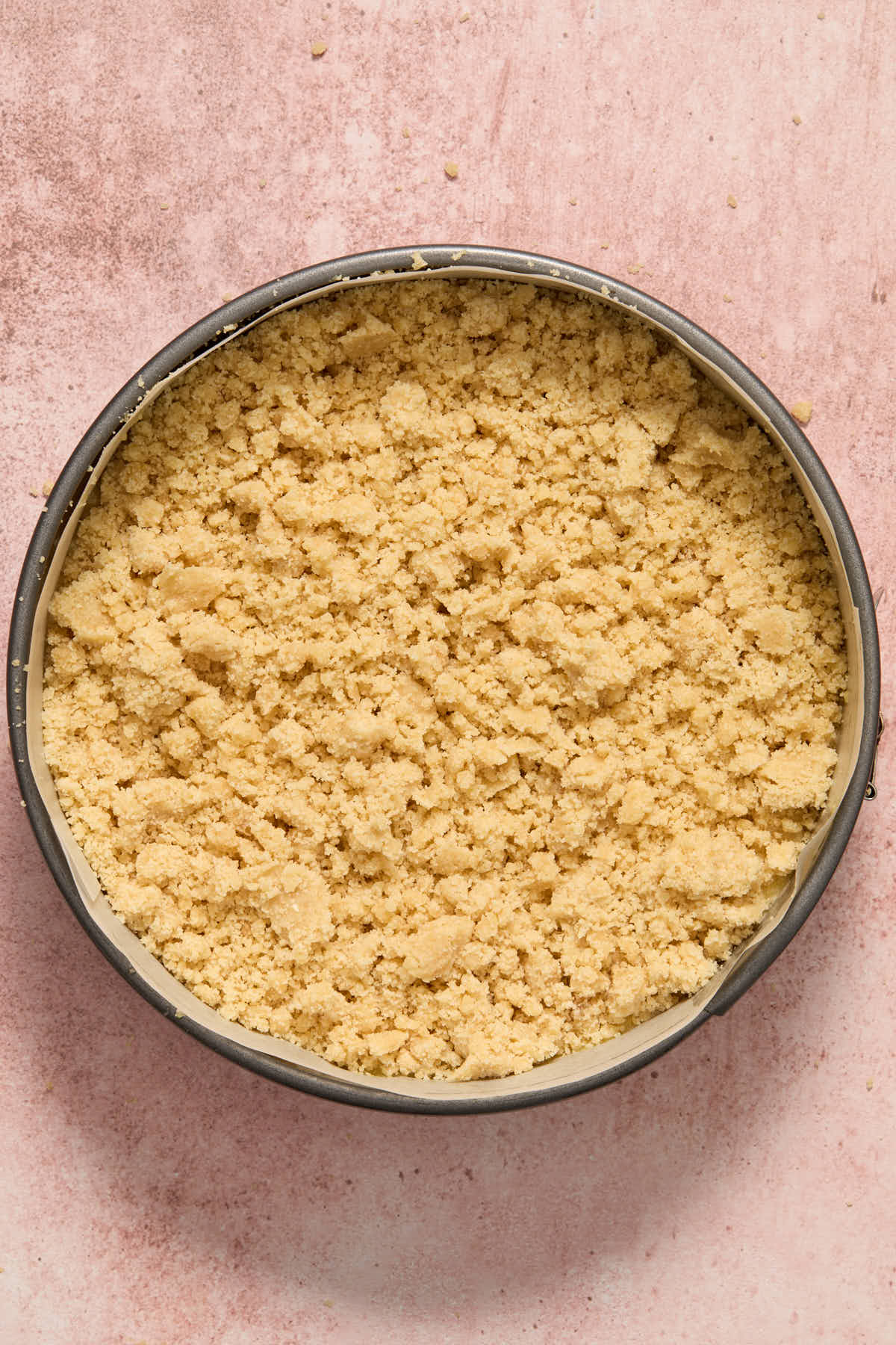 Chilled crumb topping scattered on top of cake batter in the pan.