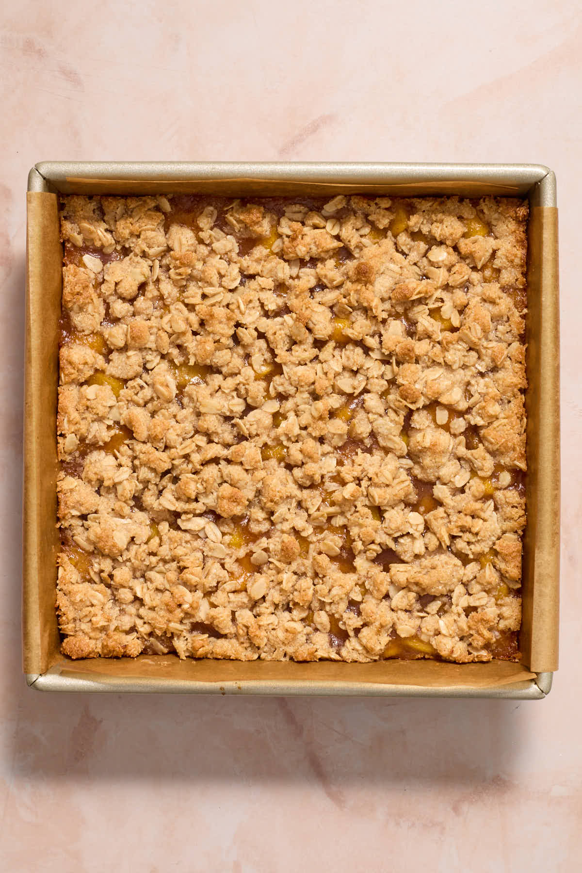 Baked peach crisp bars in the pan.