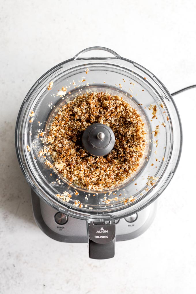 Almond crust pulsed into a crumbly mixture in food processor.