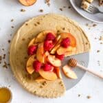 Overhead of dairy-free frozen peach pie with slices removed.
