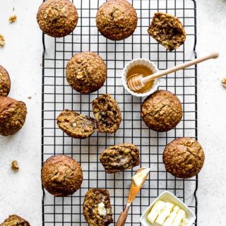 Overhead view of banana nut muffins arranged on a wire rack.