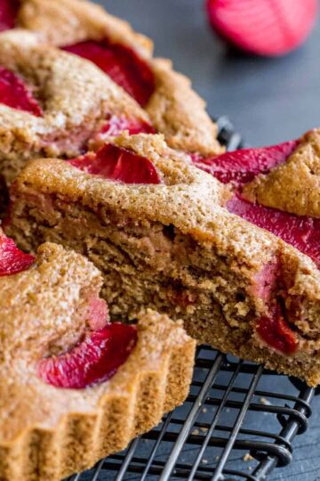 Side view of a slice of buttermilk plum cake being removed.