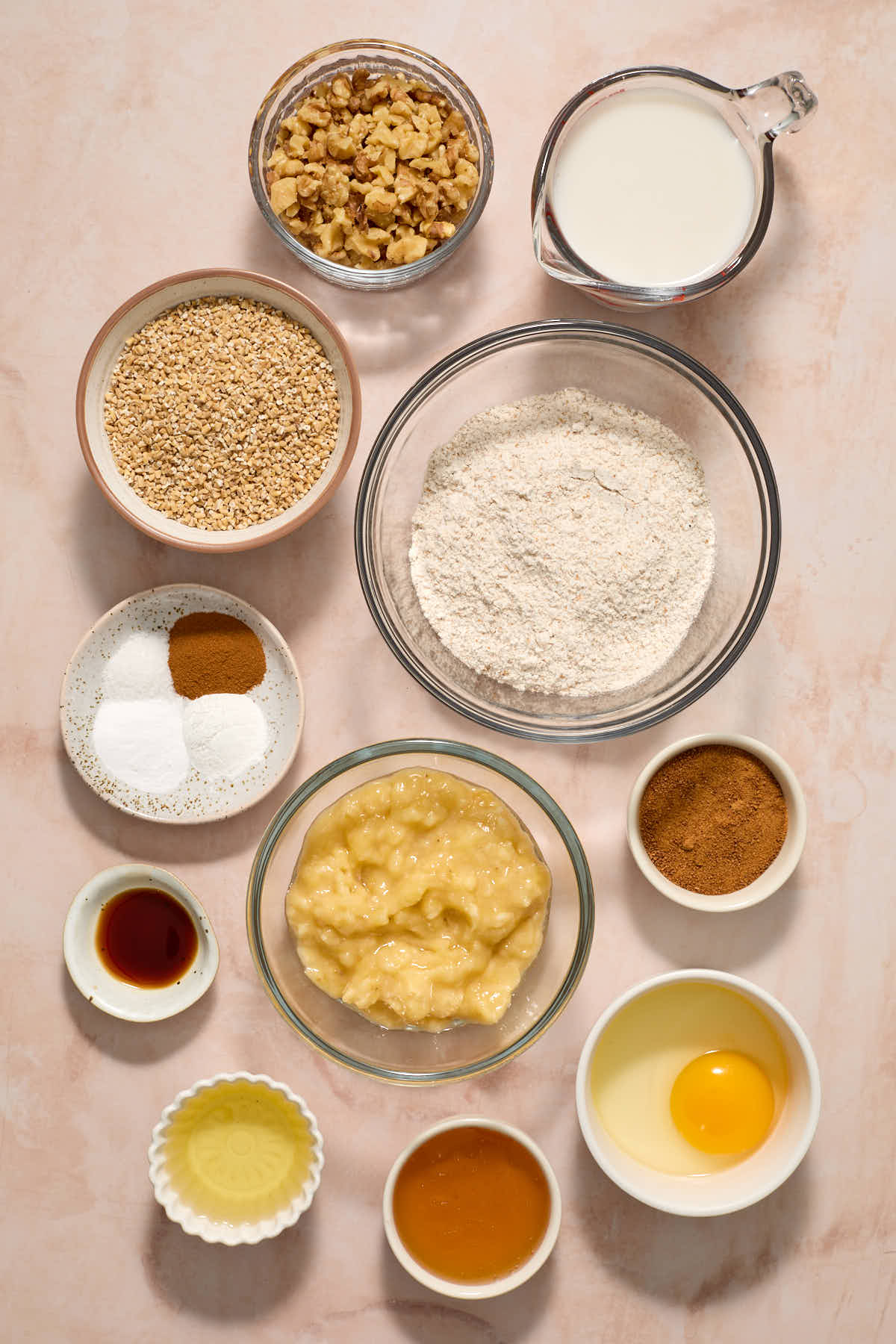 Ingredients to make banana nut muffins arranged in individual dishes.
