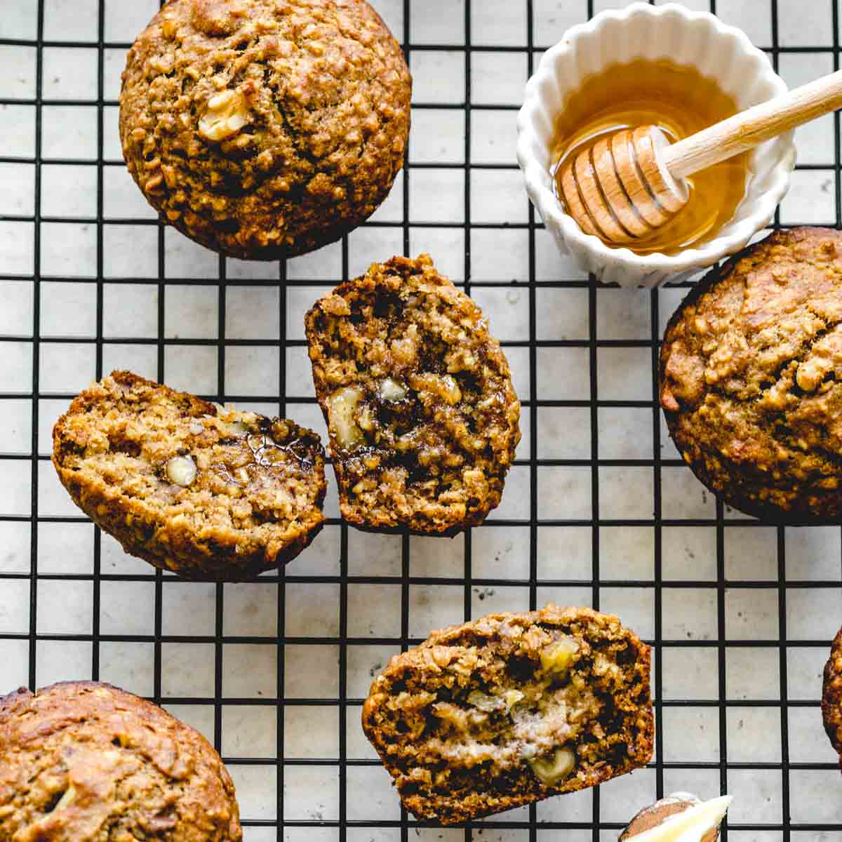 Overhead of banana nut muffins on a wire cooling rack.