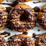 Up-close view of baked pumpkin donuts with chocolate drizzle.