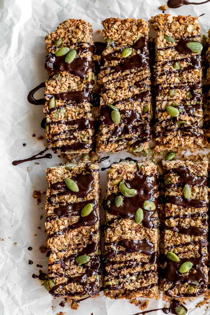Up-close view of pumpkin spice granola bars with melted chocolate on top.