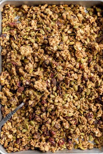 Overhead of pumpkin spice granola on a sheet pan.
