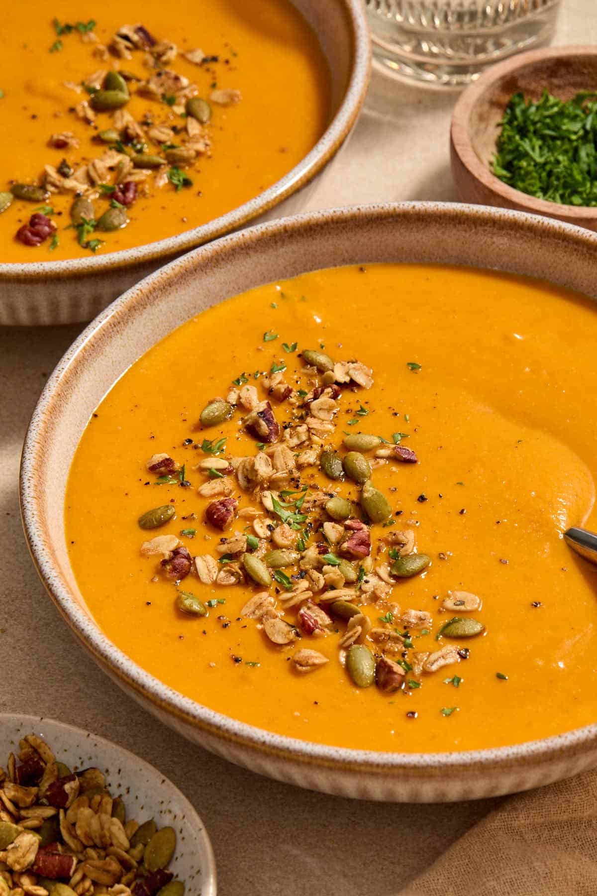 Angled view of a bowl of soup with another bowl in the background.