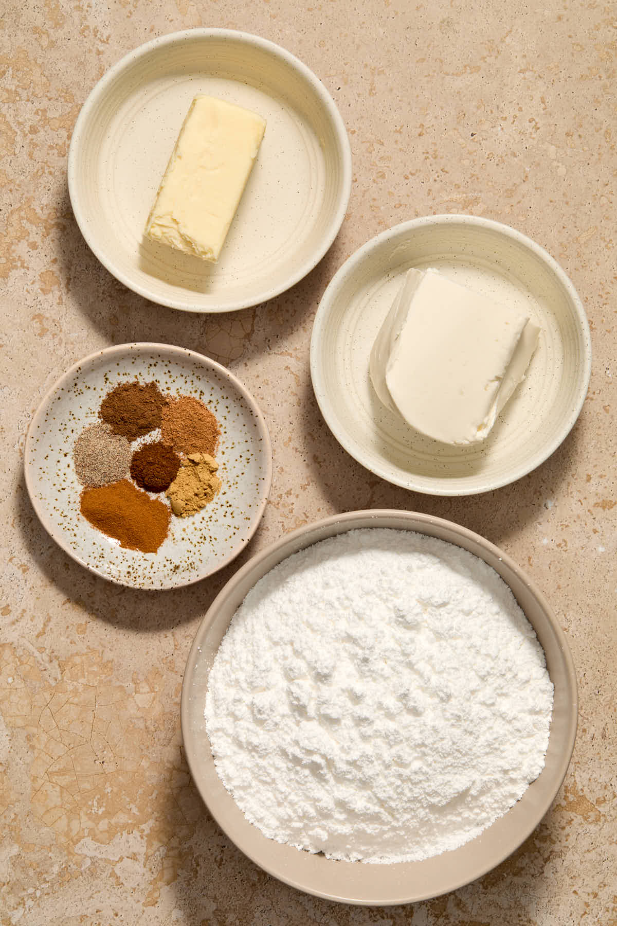 Ingredients to make the spiced cream cheese frosting arranged individually.