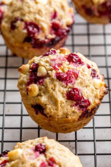 Partridgeberry muffins arranged on a wire rack.