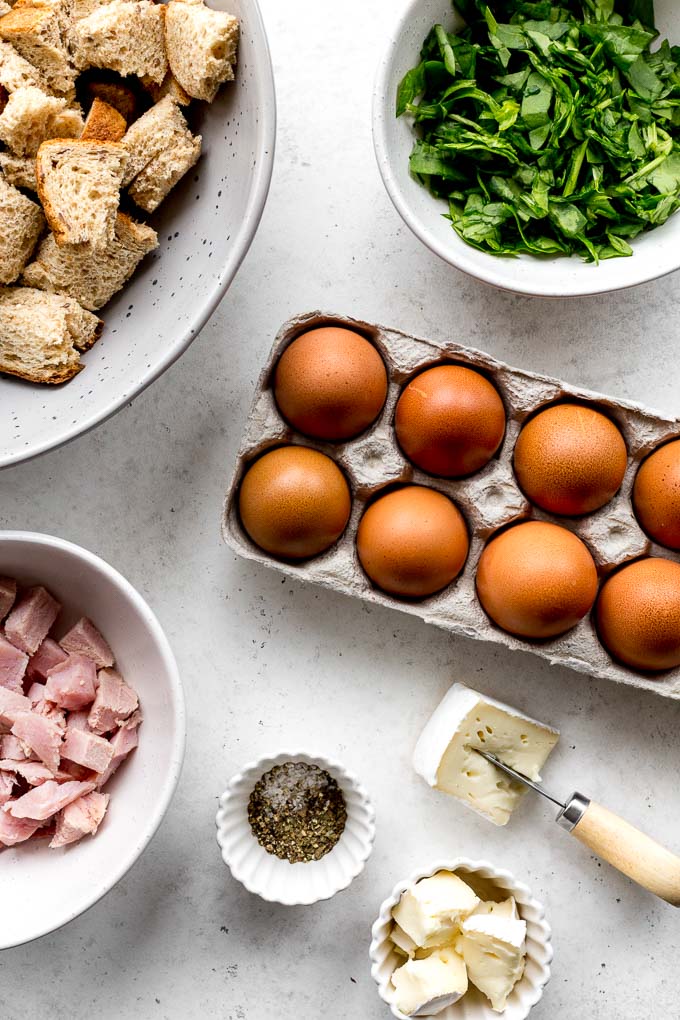 Up-close view of eggs and other ingredients to make an egg strata.